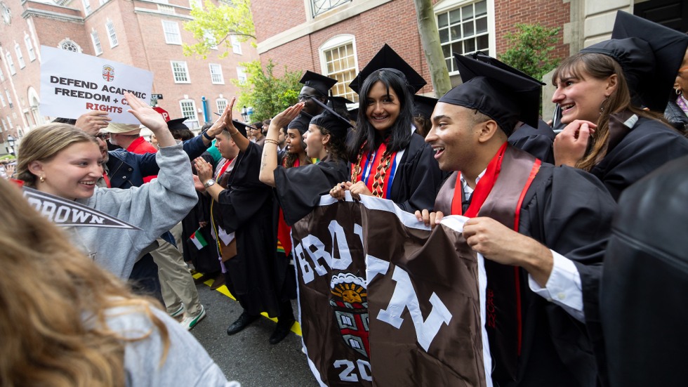 Marshals carry Class of 2025 banner during procession