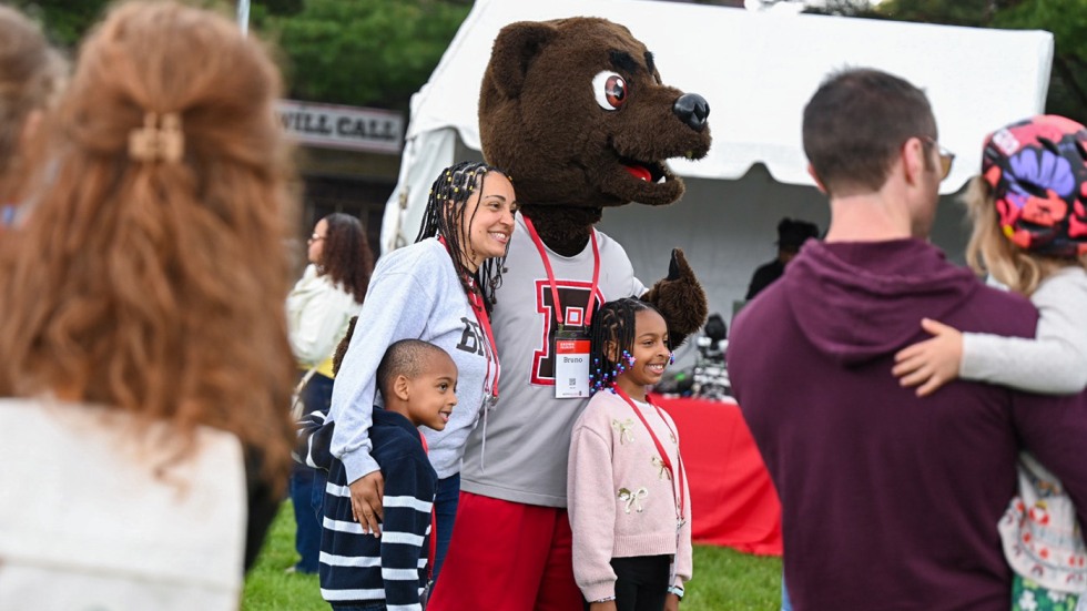 An image of a family posing with Bruno the mascot