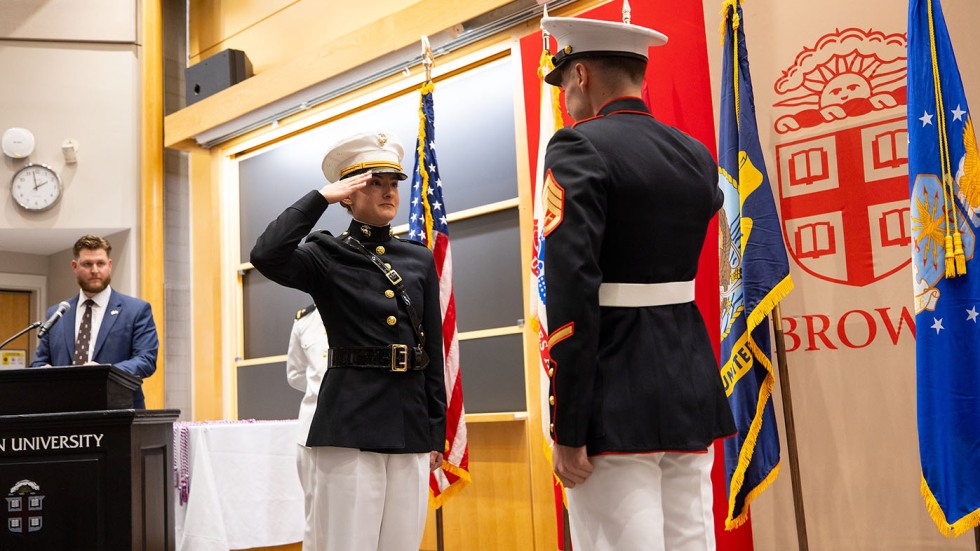 Juliette Hopgood stands at attention and salutes a fellow Marine Officer