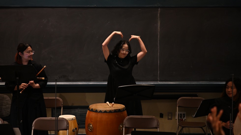 Student in ensemble creates heart shape with her arms