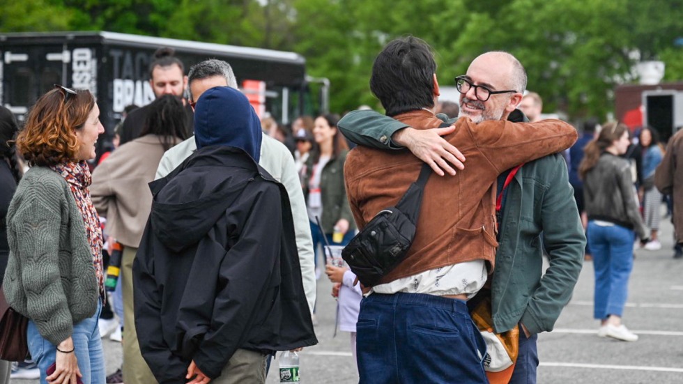 Two people hugging on the street
