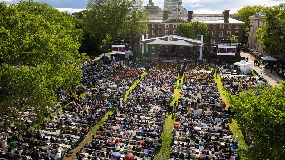 An aerial shot of the crowd seated on the College Green