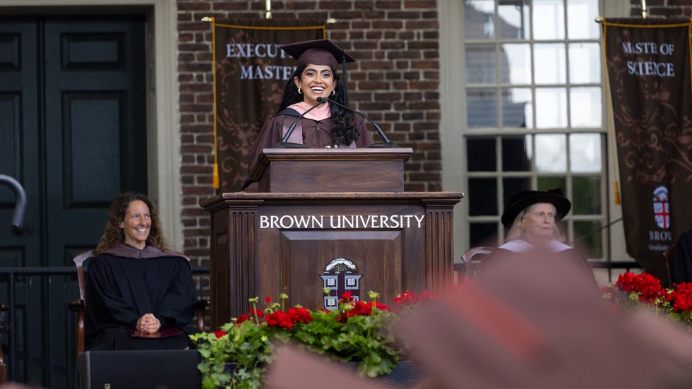 Dr. Akashleena Mallick stands at a podium addressing the crowd