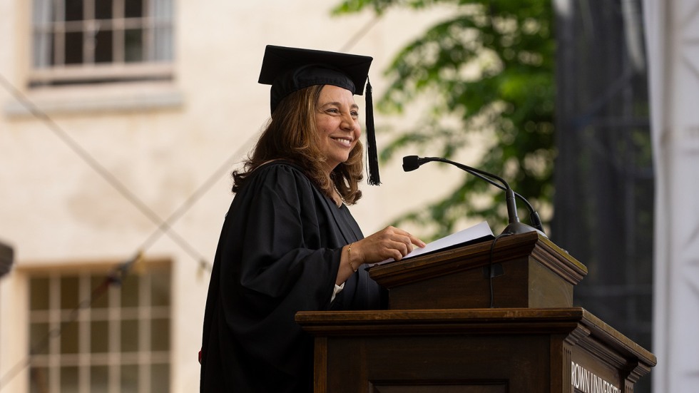 A photo of Sara Smith standing at a lectern