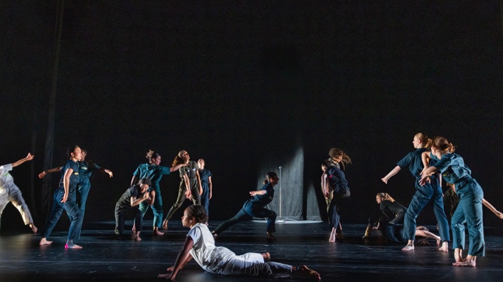 Dancers perform on stage