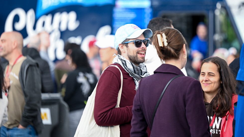 People talking and laughing in front of a food truck