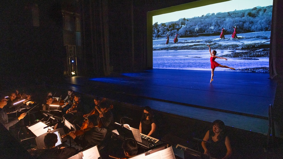 dancer in front of a video screen