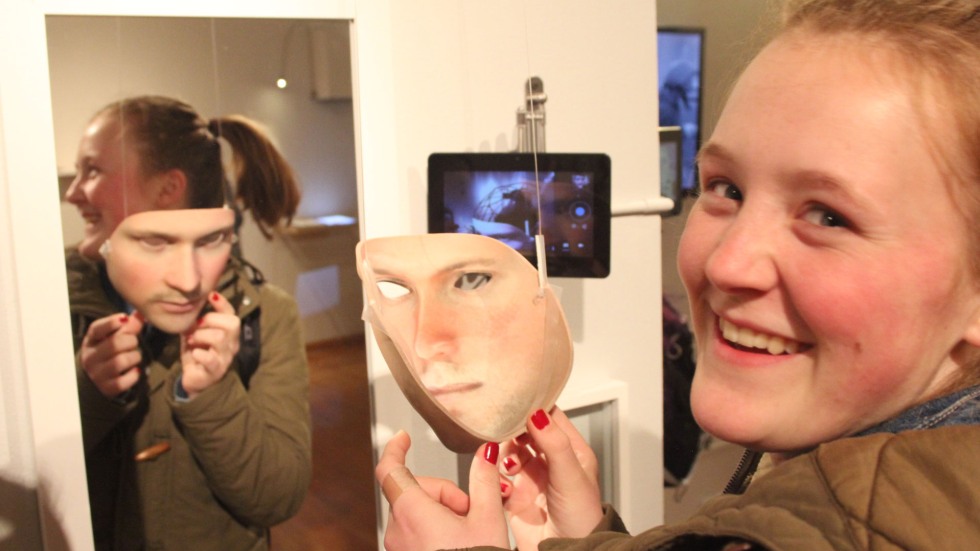 A visitor tries on Leo Selvaggio's face