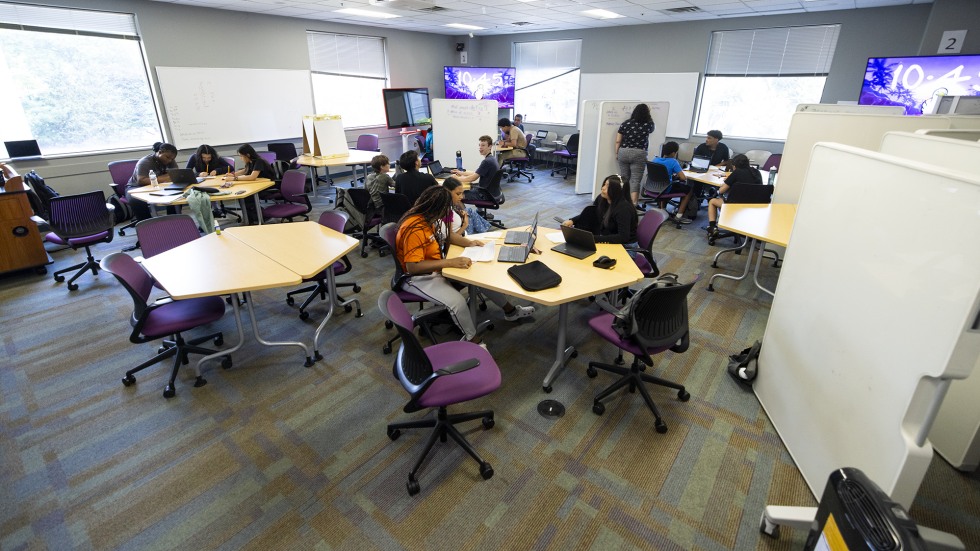 Student works in small groups in a classroom on Brown's campus. 