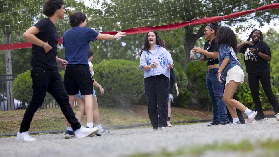students enjoy a volleyball game on Brown's campus