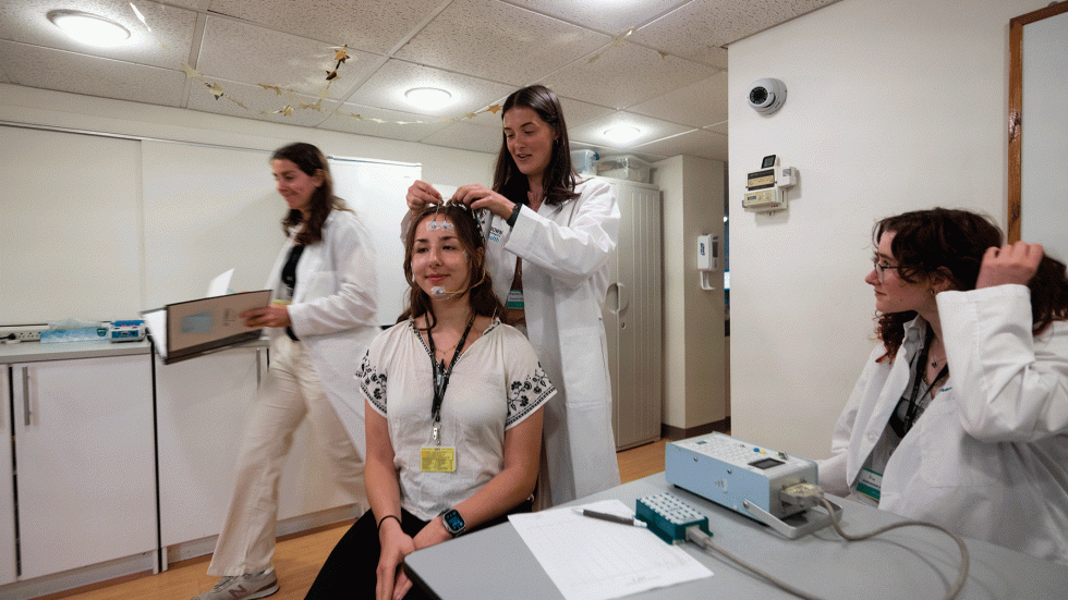 Sleep apprentices hooking up electrodes in the Bradley Sleep Research Lab