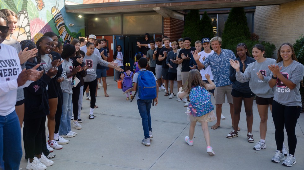 the student-athletes greeted each one with wide smiles, clapping, cheers, encouraging words and outstretched hands ready for high-fives and fist bumps. 