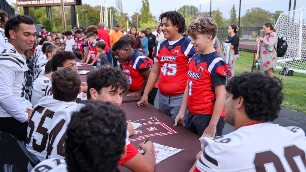 Local kids get autographs signed by Brown's football players.
