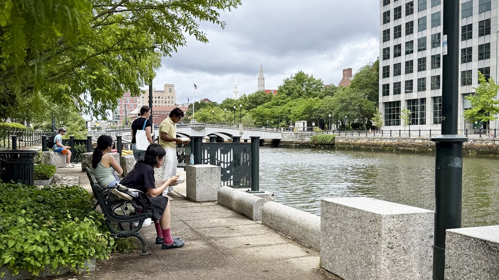 students sketch along a river