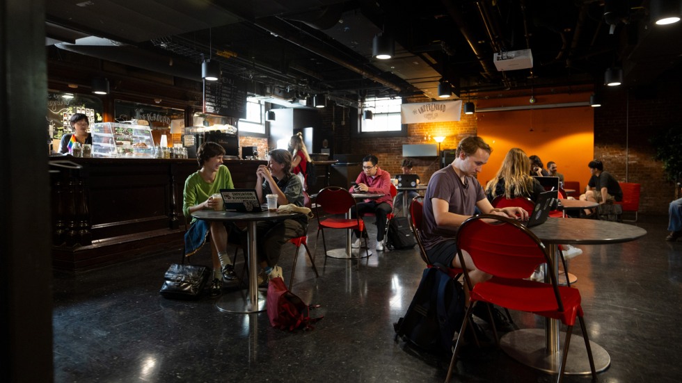 Students sit at tables in the Underground