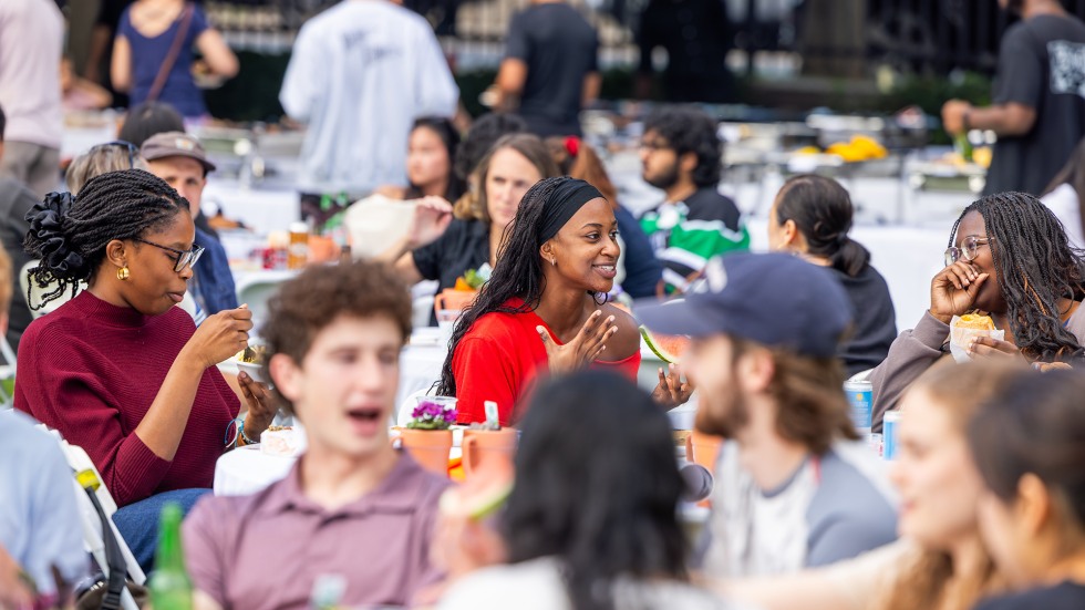 Brown students sit and enjoy a meal together at the block party event held on campus.