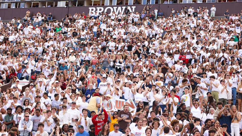 Close up: Fan cheer in the stands at Harvard-Brown football game 