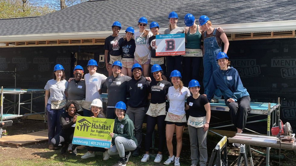 students and staff pose in hard hats
