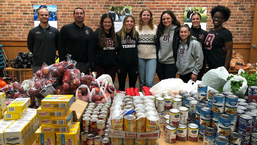 group of people by table of food donations
