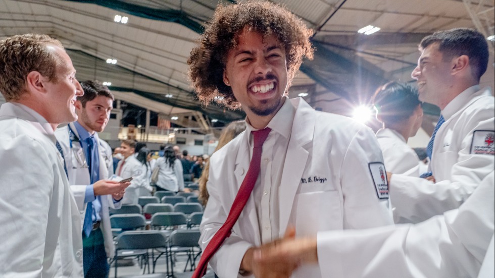 student at white coat ceremony
