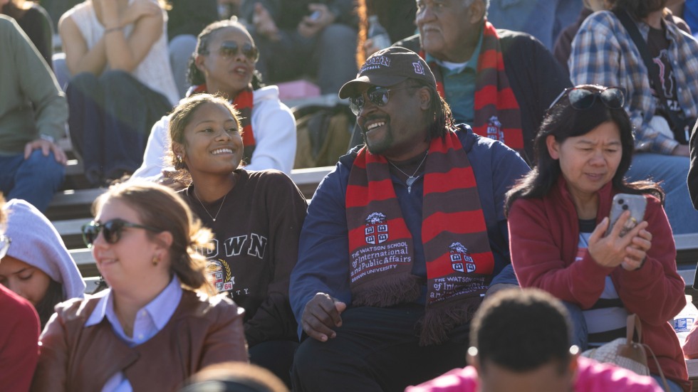 family in bleachers at football game