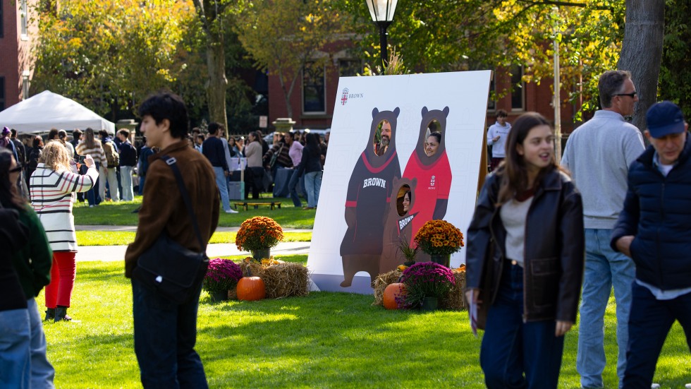 Families stop to stand behind a Bruno cut out to take a photo.