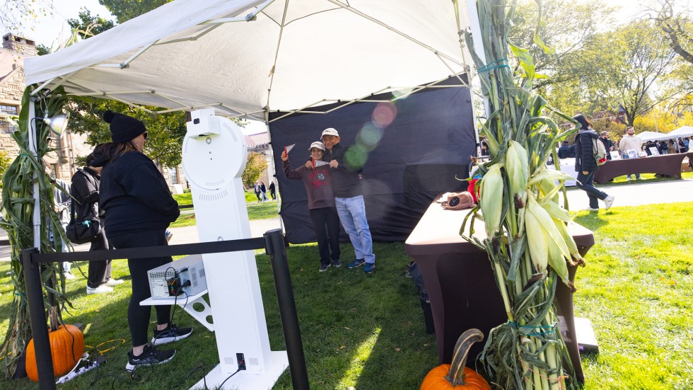 Brown community members stop in a Photo Booth to take a photo together.