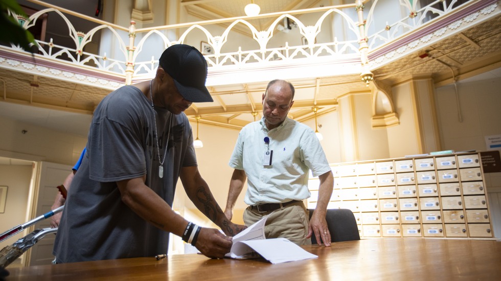 John Colarusso reviews project plans with other contractors on campus