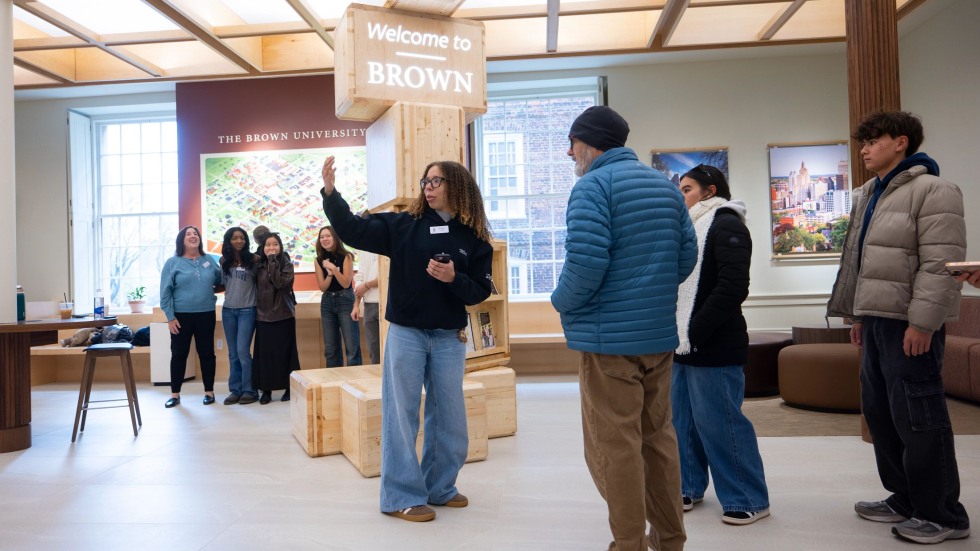 Tour coordinator Mia-Nathalie Pridgen speaks with a group of people