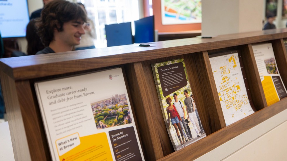 admissions materials lined up along the welcome desk