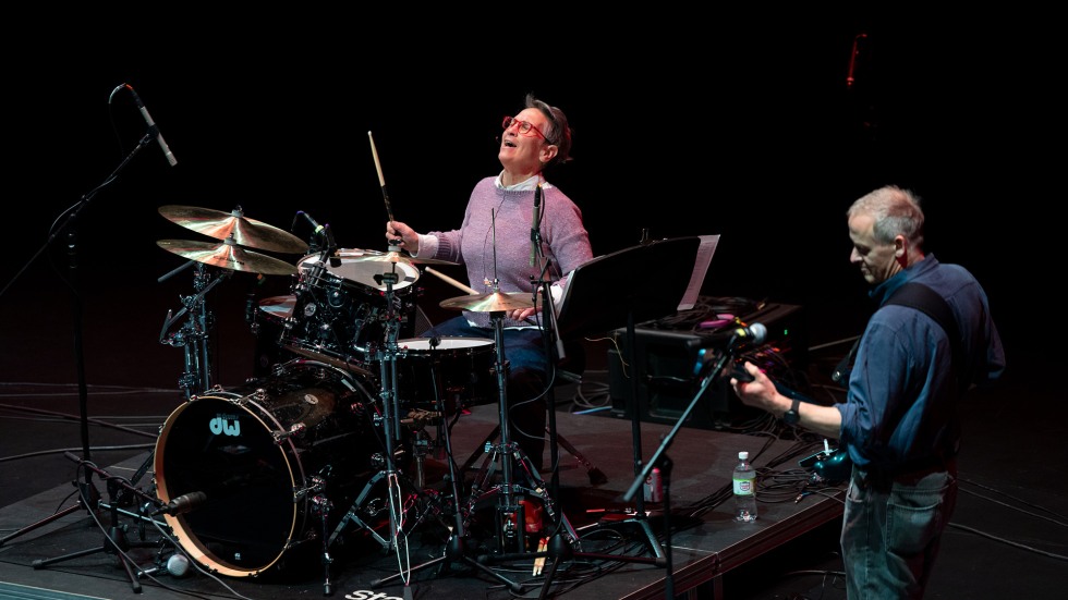 Brown provost Janet Blume sings and plays drums during Battle of the Bands. 