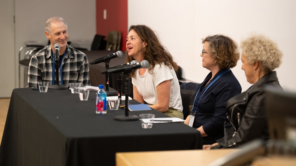 four panelists speak at a table