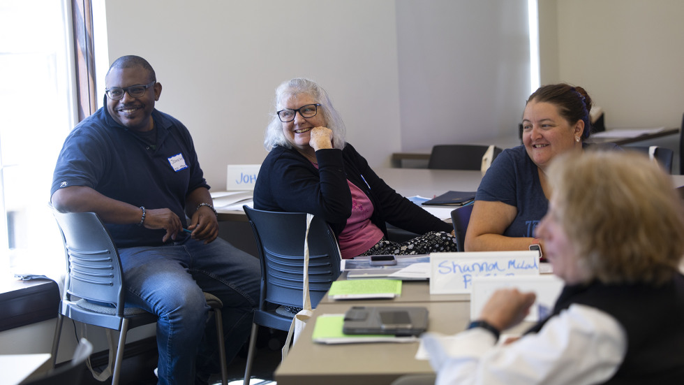 Providence teachers and librarians speak, share and smile together in a professional development class held at Brown's campus. 