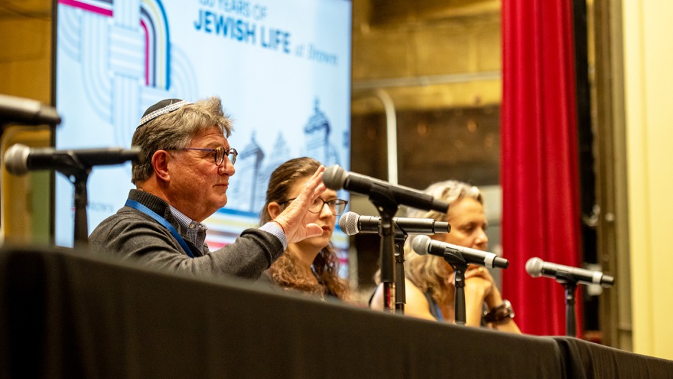 three panelists on stage in Alumnae Hall