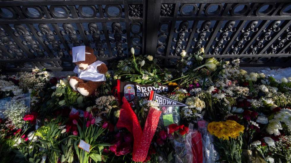 Bruno the teddy bear among the flower at the memorial