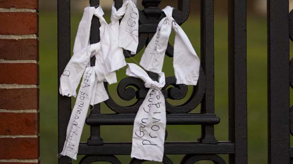 ribbons with writing on them hang from iron gates