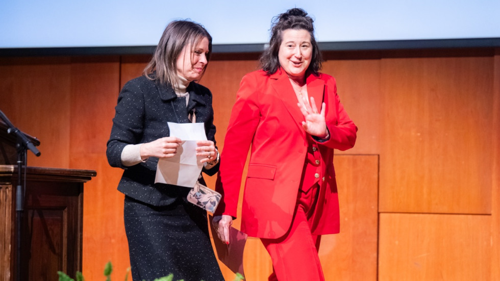 Two people walk off the stage in the Salomon Center