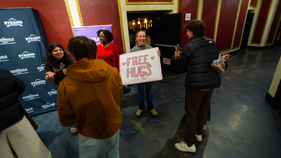 Students offer free hugs at show