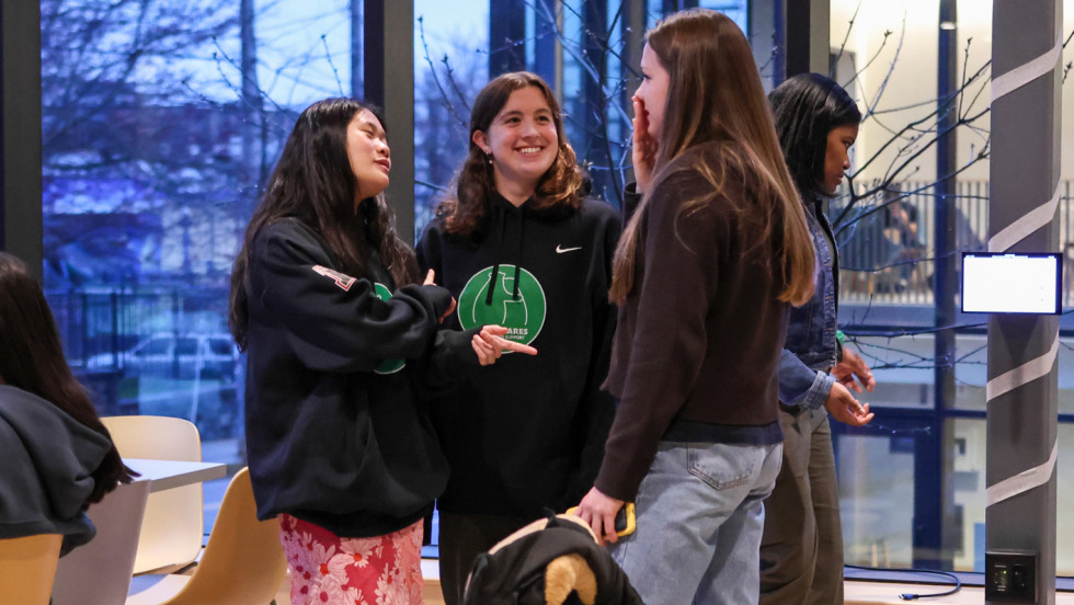 Group of Bruno Cares grads chat during ceremony