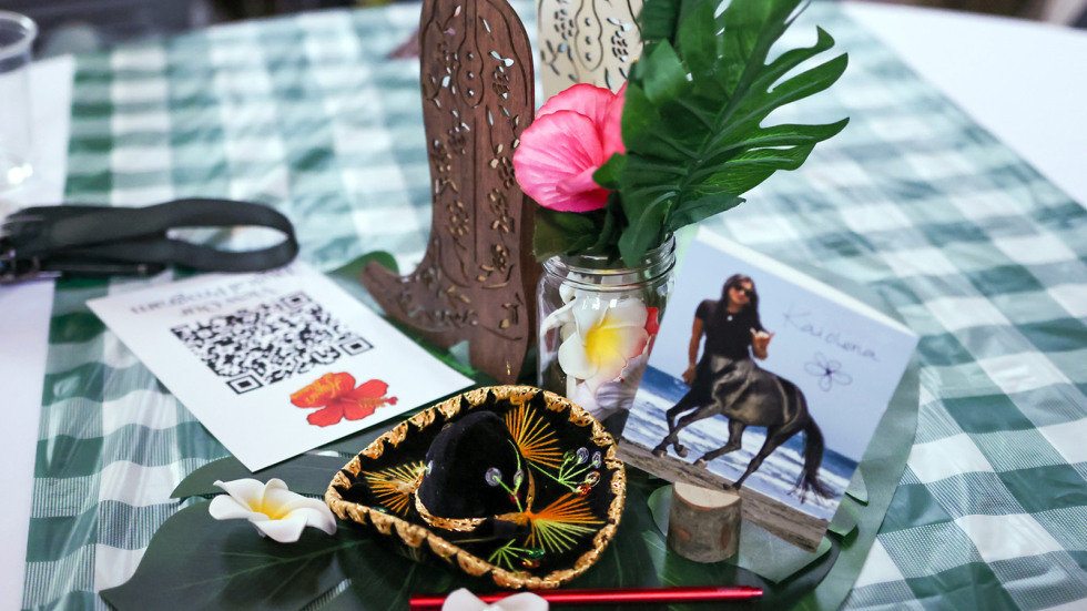 A centerpiece decoration at the luau includes nods to the paniolo theme with a tiny sombrero and cowboy boot