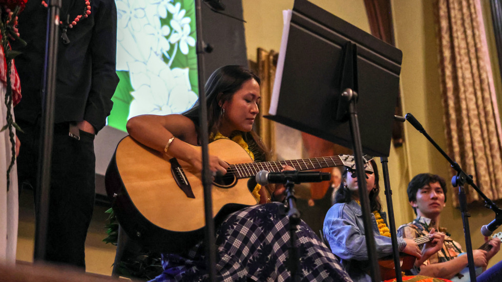 Skyler Recel-Chang plays the guitar during a jam session at the lu'au