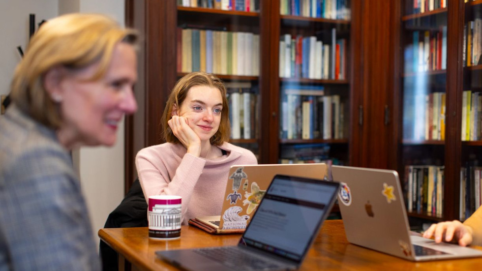 Students and professor meet to discuss research