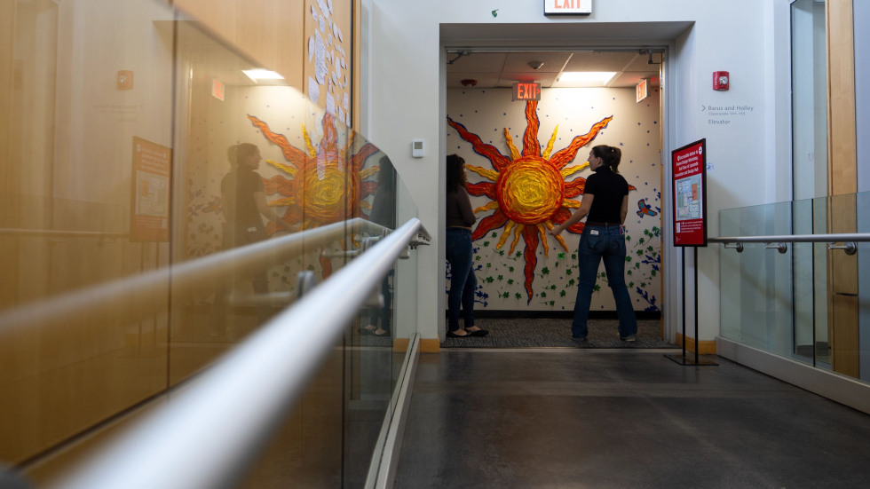 View of the tape art mural through a doorway to the hall