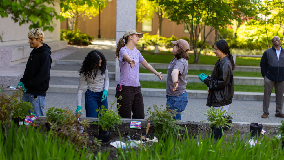 Students gather and plant at the garden