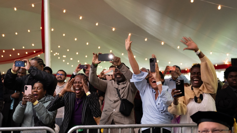 People cheering on the graduates