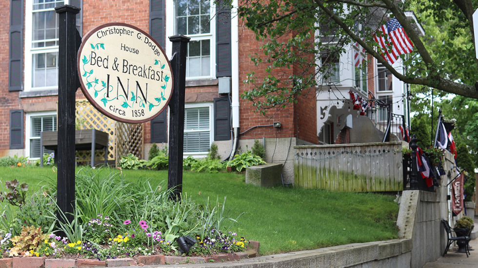 flowers wrap around the sign for the Christopher Dodge House, a bed and breakfast in Providence.