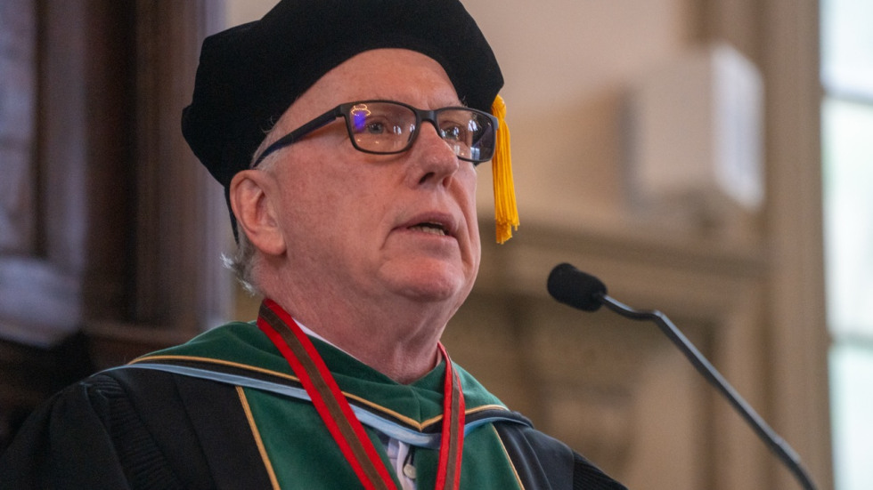 Louis Rice at a podium delivering the faculty address