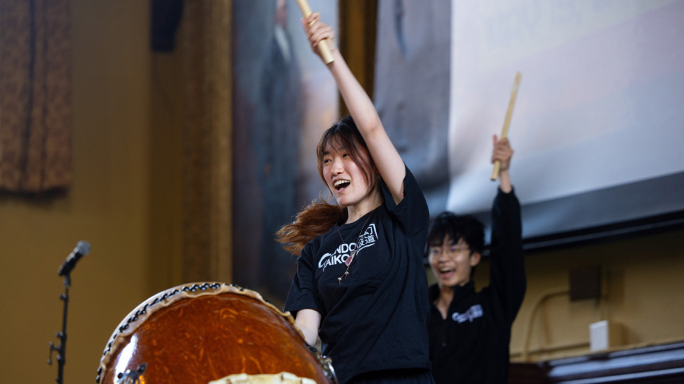 A Taiko drummer performs in Sayles Hall 