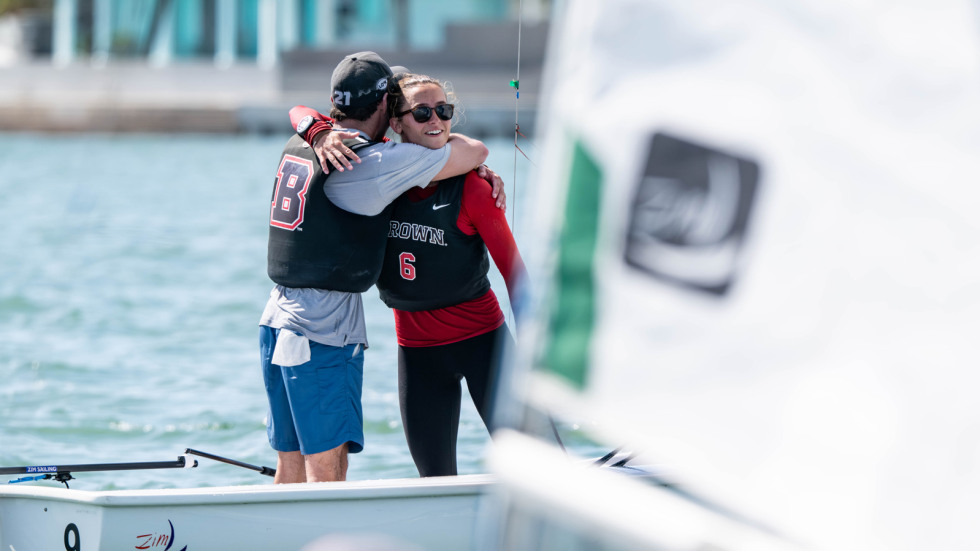 Sailors hug on boat