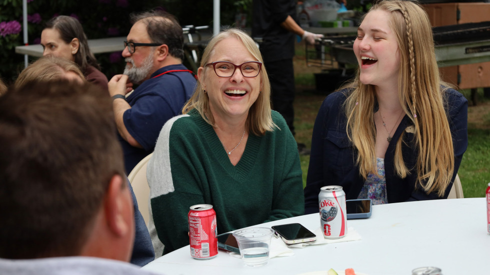 people laughing at an outdoor table